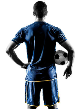 Fototapeta one caucasian soccer player man standing Rear View in silhouette isolated on white background