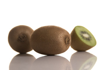 three kiwis on white background
