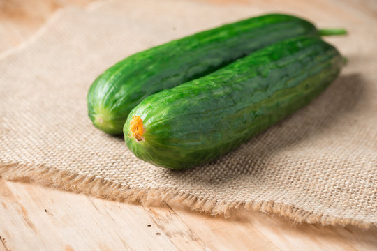 Fresh two cucumbers on rustic wooden table