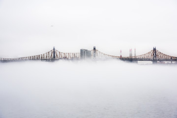 A dense fog covered New York City during the winter's day on January of 2018. View of Ed Koch Queensboro Bridge.
