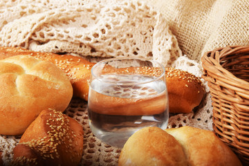 fresh crunchy bread rolls and a glass of puremineral water