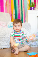 Fototapeta premium Cute boy in a spring easter studio decorations