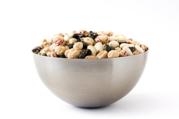 Uncooked assorted legumes in metal bowl isolated on white background.
