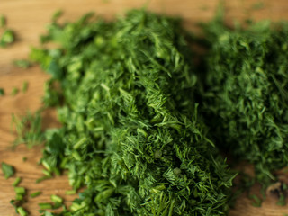 finely chopped greens on a chopping board.