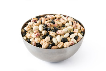 Uncooked assorted legumes in metal bowl isolated on white background.