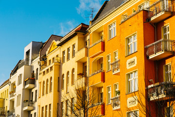Fototapeta na wymiar orange buildings in a row at berlin with blue sky