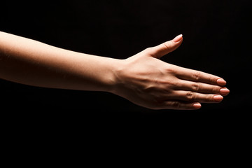Obraz na płótnie Canvas Hand ready for handshake isolated on black