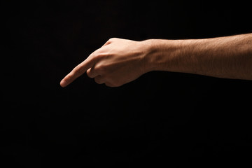 Fototapeta na wymiar Hand gestures - man pointing, isolated at black