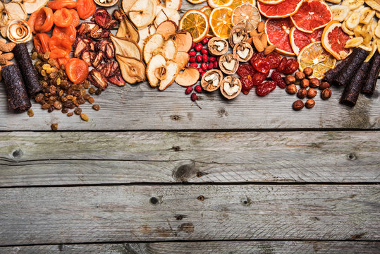 Different dried fruits on a wooden surface
