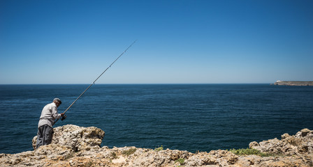 Fisher man on the algarve coast line