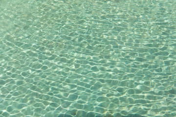 Green swimming pool rippled water detail