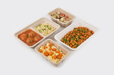 Healthy food delivery for fitness nutrition or diet. Daily meals in paper boxes on a white background