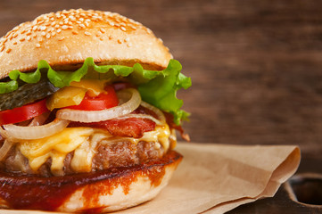 mouth-watering delicious homemade burger used to chop beef on the wooden table.