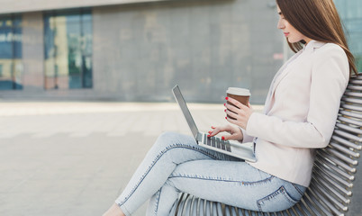Caucasian businesswoman working with laptop outdoors
