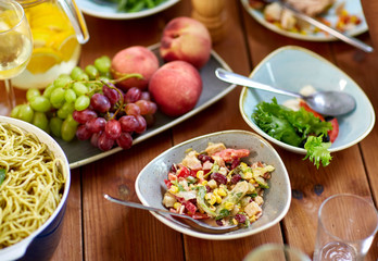 salad, fruits and pasta on wooden table