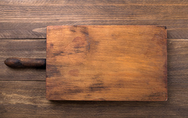 Brown wooden tray on wooden table.