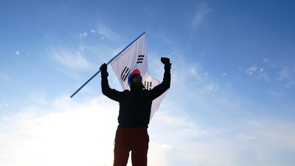 Male fan with South Korean flag rejoices and supports athletes
