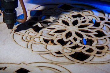 The laser cuts out a tree in the form of a mandala  - 188574699