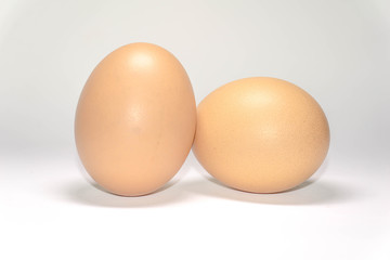 two chicken eggs on a white background.