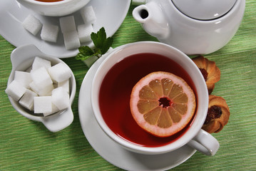 fruit tea with a cookie in white porcelain