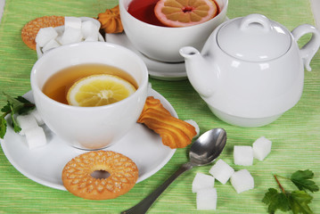 grapefruit and lemon tea with sweet cookies and sugar cubes