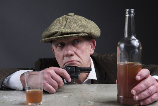 Victorian Gangster Drinking Whisky And Holding A Hand Gun 