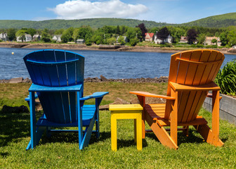 Adirodack chairs overlooking a river.