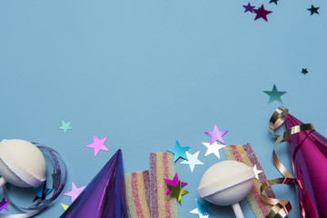 Party background image with party hats, string and colourful sweets, taken with copy space 
