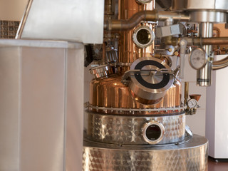 alembic still for making alcohol inside distillery, destilling spirits