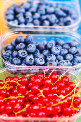Berry fruits at marketplace  - organic  blueberries, raspberries, strawberries, cherries. Healthy local food market concept..