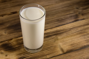 Glass of milk on wooden table