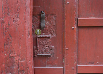 Red vintage wooden shabby door with a texture