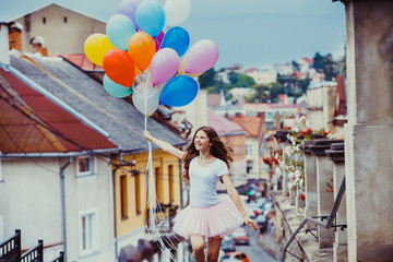 Girl with colorful latex balloons