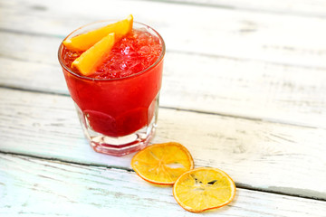 Red alcohol cocktail with orange slices and ice