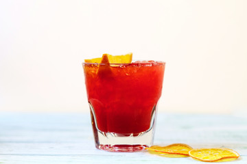 Red alcohol cocktail with orange slices and ice
