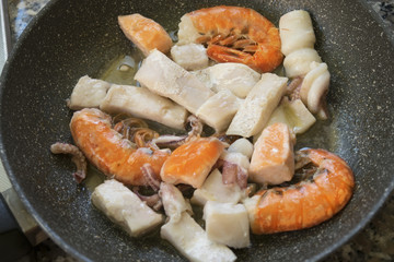 preparing mixed fish pasta
