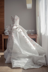 Fototapeta na wymiar Beautiful wedding dress with window light