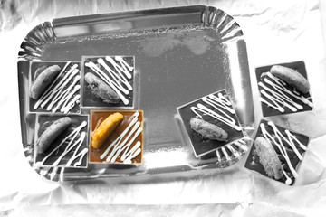 colored pastry between pastries in black and white