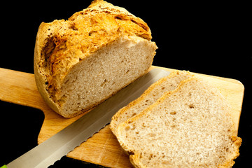 Sliced Bread on cutting table, black background