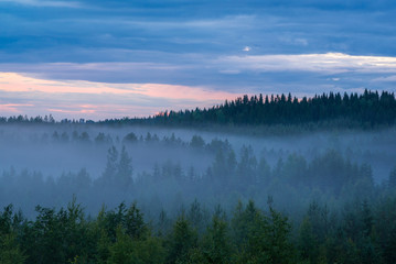 Misty summer night landscape in Finland