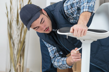 Handyman adjusting swivel chair
