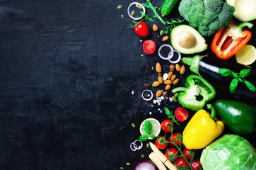 Set of fresh vegetables on a black background. Aromatic herbs, onion, avocado, broccoli, pepper bell, eggplant, cabbage, radish, cucumber, almonds, rucola, baby corn. Banner