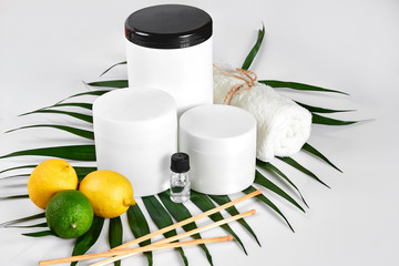 White bottles and two whole lemon and lime isolated on white background. The concept for advertising cosmetics