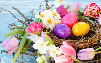 Happy Easter: nest with Easter eggs, feathers, tulips and daffodils:) - 188586416