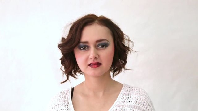Beautiful fashion model with makeup and short curly hair