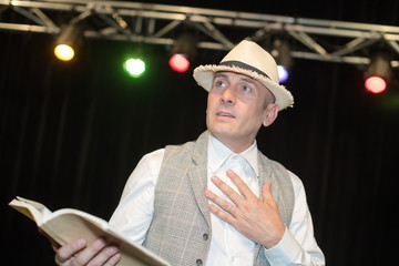 comedian in the box on stage in theater