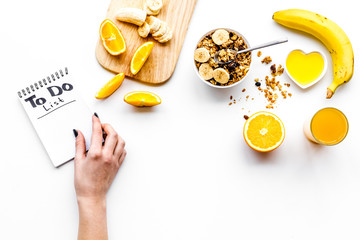 Morning habits of successful people. Healthy breakfast porridge with fruits and planning the day. White background top view copy space