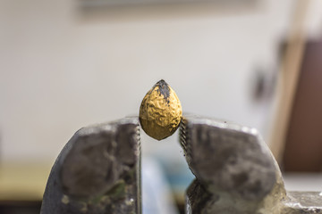 Nut in a vice. Feel under pressure.