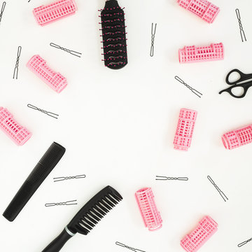 Hairdresser tools - combs, curlers, and hair clips on white background. Beauty composition. Copy space. Flat lay, top view
