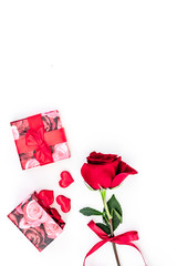 Gift for Valentine's day. Red rose, gift box, red hearts signs on white background top view copy space